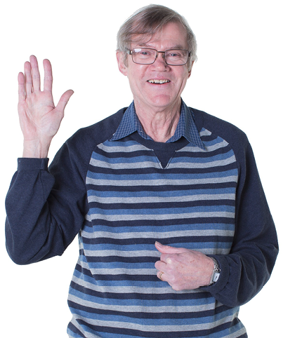 An elderly person pointing to themselves with one hand, and their other hand up.