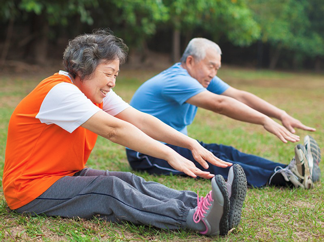 2 people stretching outside.