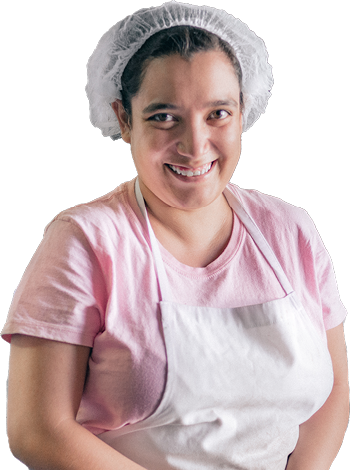 A person with disability wearing an apron and a hair net for their job.