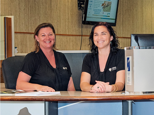 2 Council staff members behind a desk.